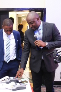 CEO, Verve International, Charles Ifedi,making a cardless transaction on POS at the launch of Verve paycode